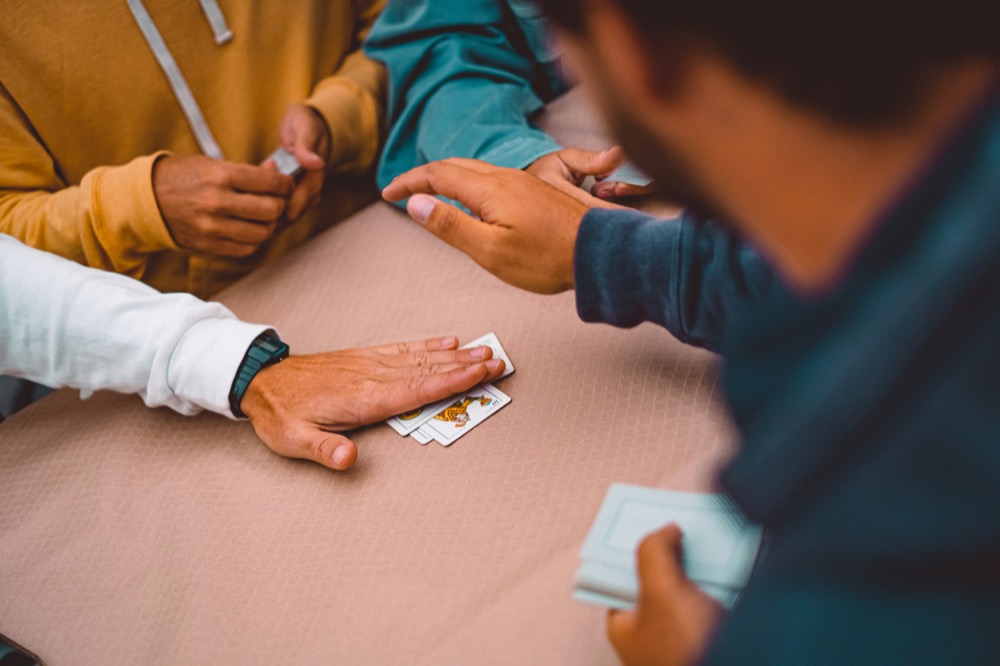 Residents enjoying a card game together in a common area
