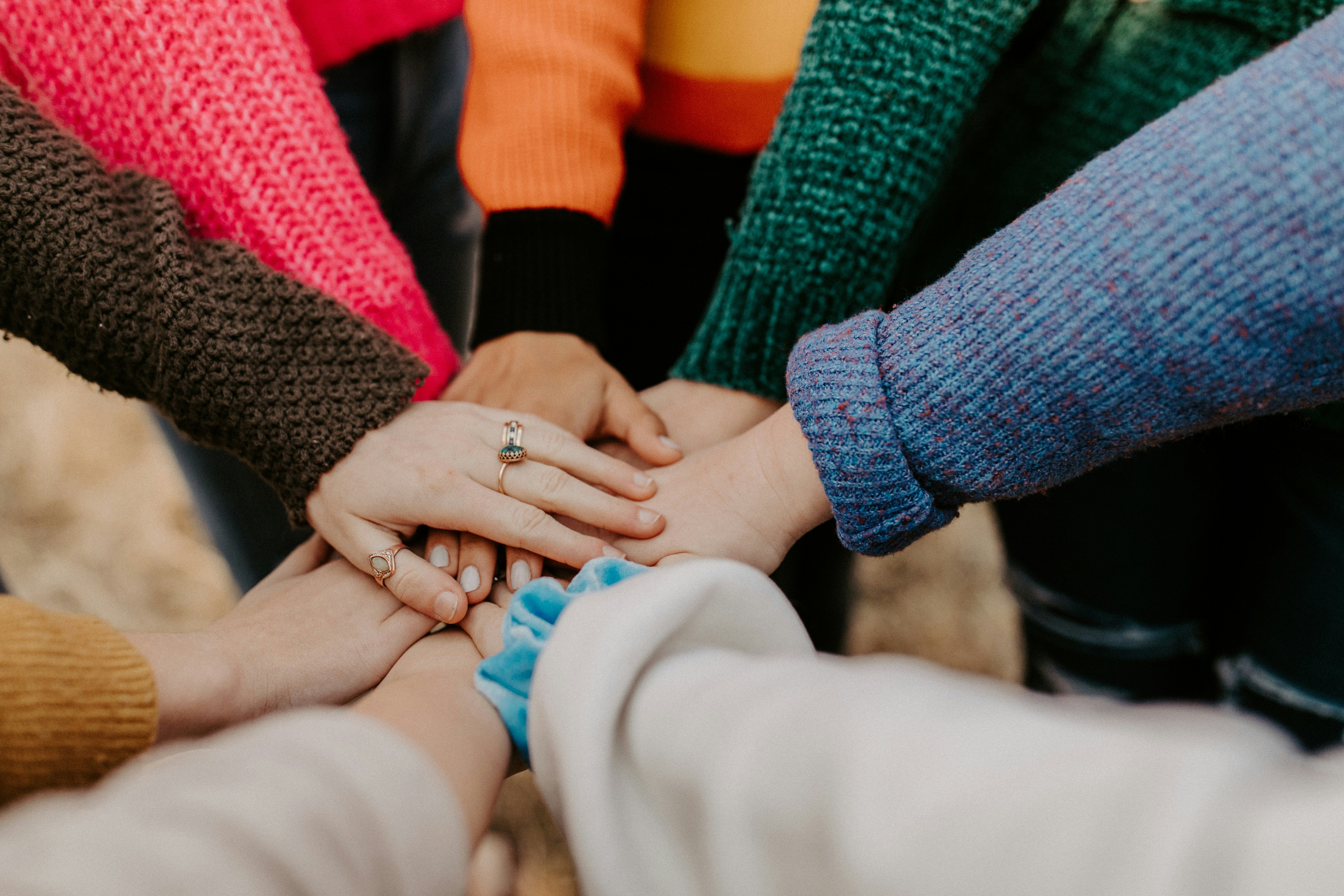 Residents and caregivers joining hands in a warm, supportive moment together